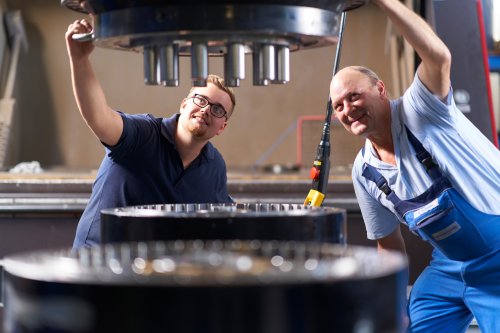 Technicians inspecting a large gearbox