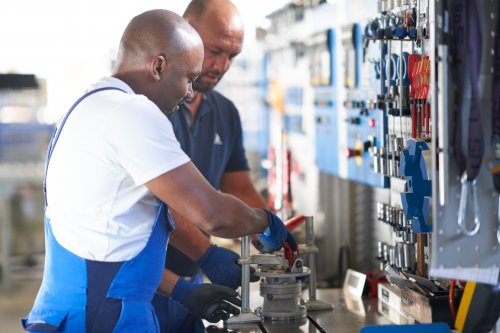 Two mechanics working on gearboxes